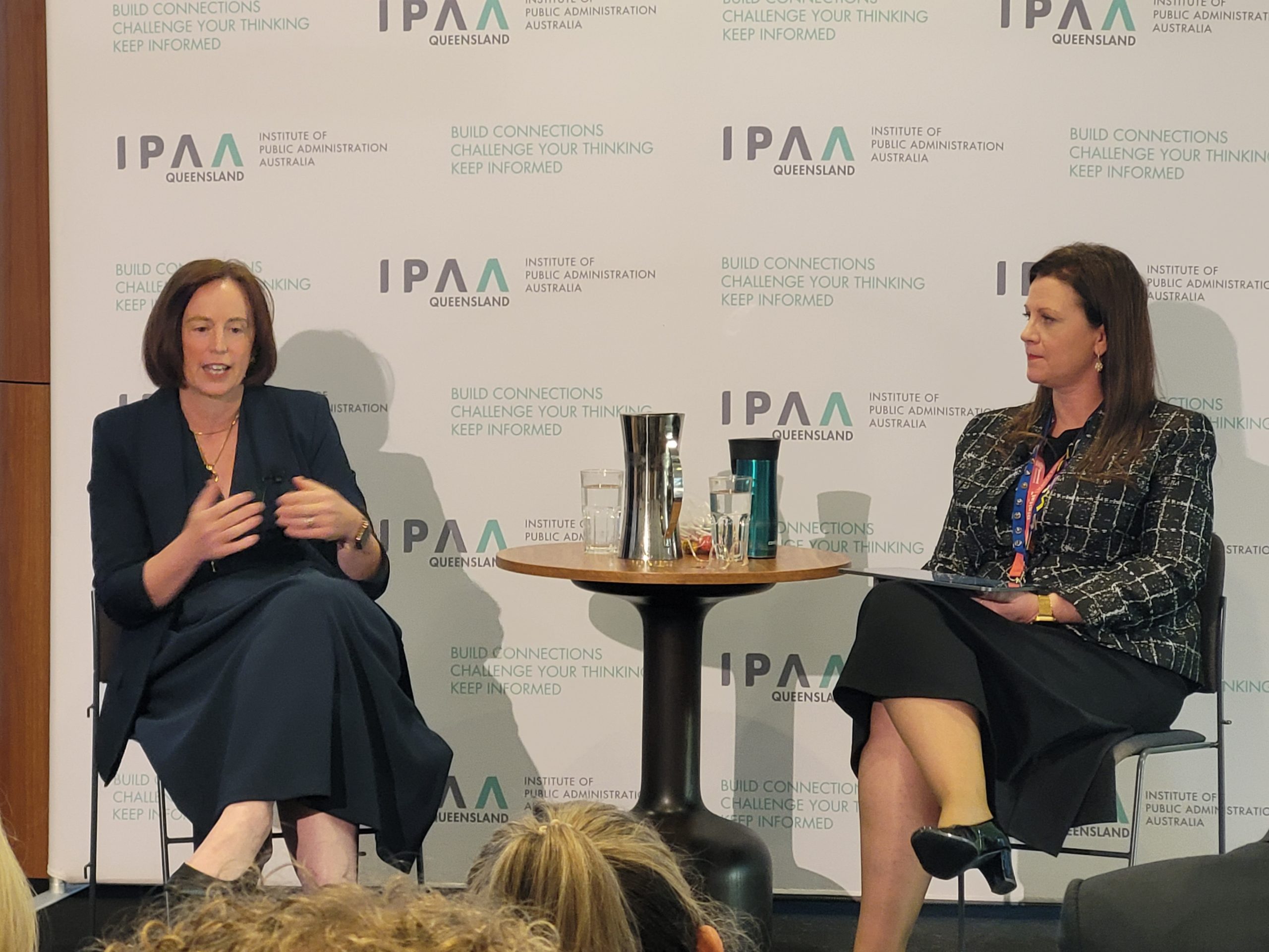 Sally Stannard and Anne Moffat in conversation on stage at Stewards on the Couch, with the audience looking on